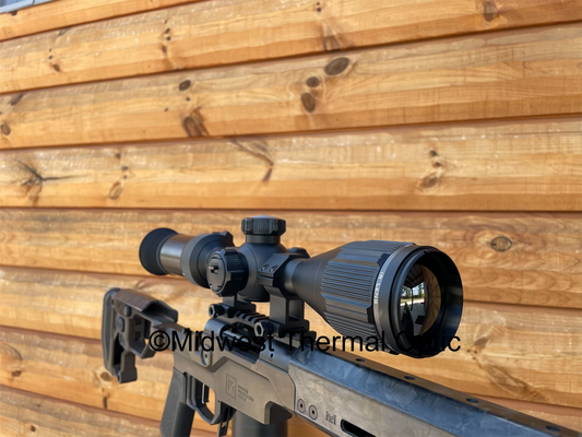 black scope with wood wall in background